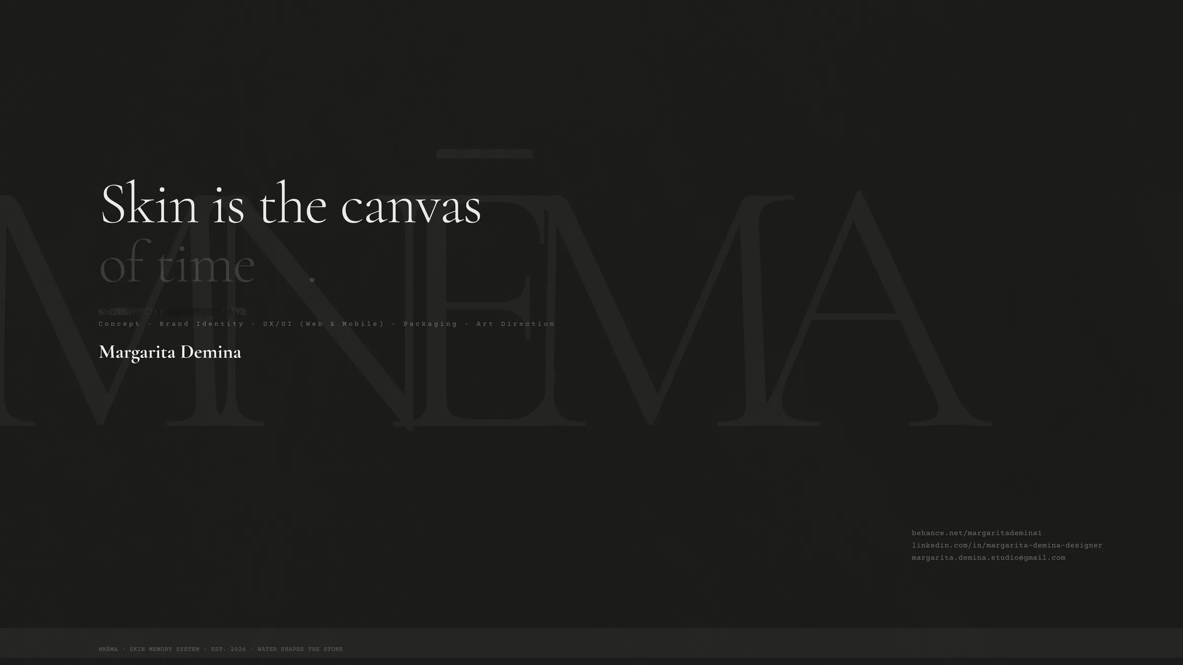 MNĒMA — black serum bottle and packaging on volcanic stone
